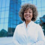 Portrait of a mature female doctor standing in front of her medical clinic